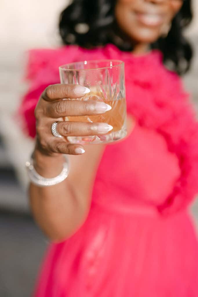 woman enjoying cocktail at a wedding at château de chantilly
