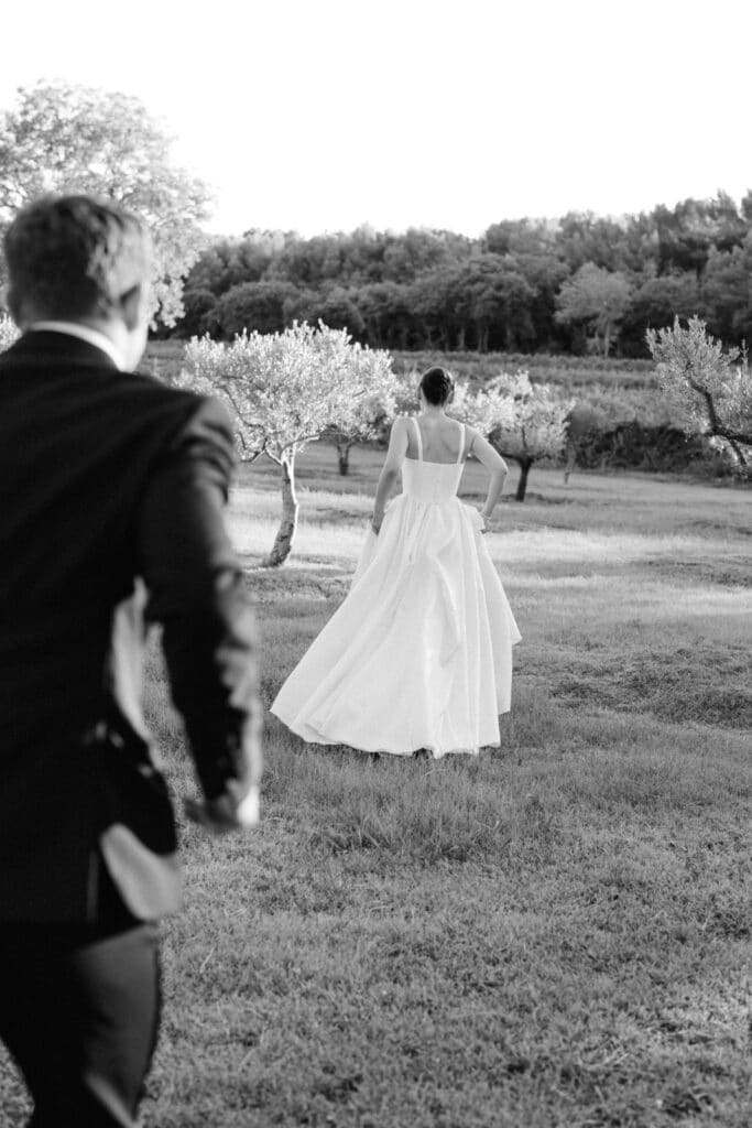 bride and groom running in olive tree garden- how-to-feel-comfortable-in-front-camera